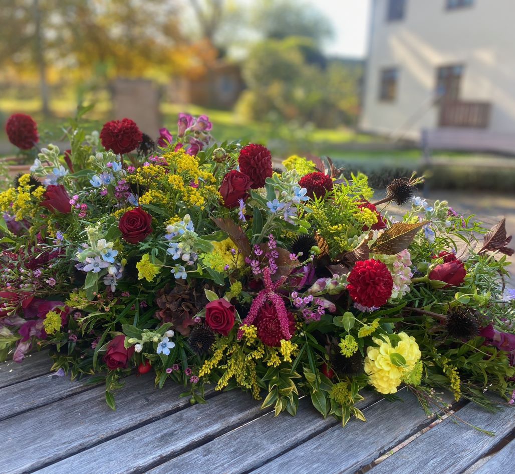 Red, yellow and white flowers at celebrant-led funeral